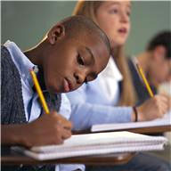 Young student working at his desk.